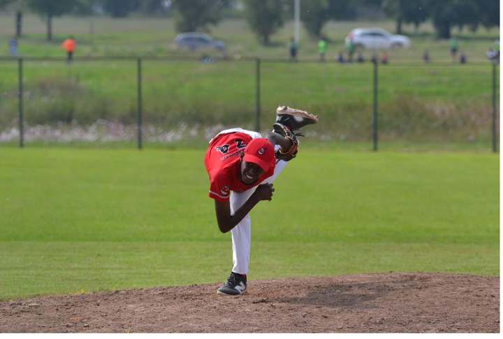 Tinashe driving toward the plate, arm cocked