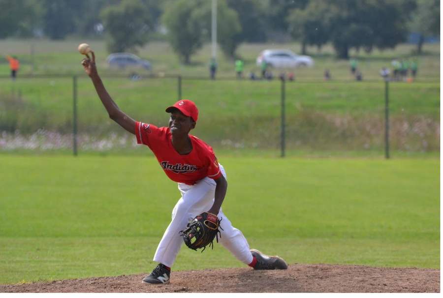 Tinashe on base beside an opposing Cardinals first baseman
